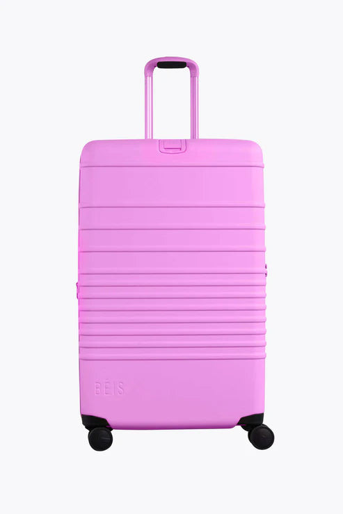 Compact carry - on travel bag with spinner wheels for easy maneuvering in airportsThe Large Check-In Roller in Berry Compact carry - on travel bag with spinner wheels for easy maneuvering in airportsThe Large Check-In Roller in Berry