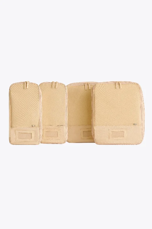 Lightweight nylon duffel travel bag with multiple exterior pockets for quick accessThe Compression Packing Cubes 4 pc in Beige Lightweight nylon duffel travel bag with multiple exterior pockets for quick accessThe Compression Packing Cubes 4 pc in Beige