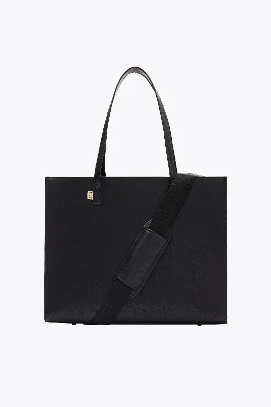 Vintage leather travel bag with brass accents for a classic and sophisticated lookThe Large Work Tote in Black Vintage leather travel bag with brass accents for a classic and sophisticated lookThe Large Work Tote in Black
