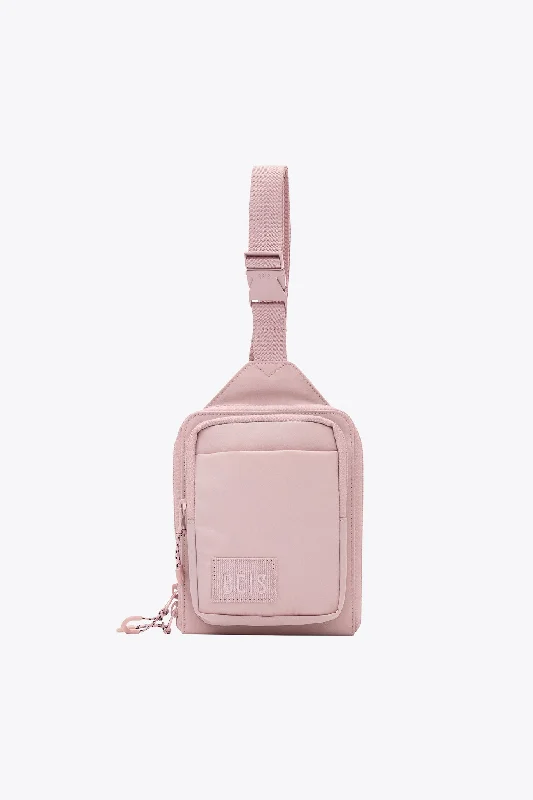 Travel bag with a built - in power bank charger for on - the - go device chargingThe Sport Sling in Atlas Pink Travel bag with a built - in power bank charger for on - the - go device chargingThe Sport Sling in Atlas Pink